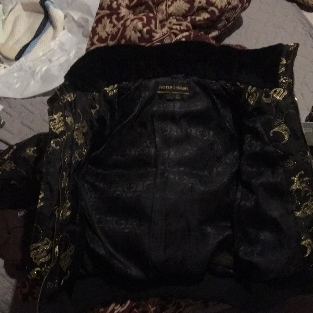 One black jacket w/all gold RW sown on all over the outside in gold cursive